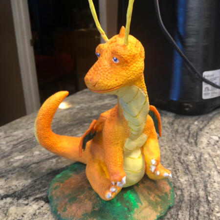 A medium Dragonite statue sitting on a counter